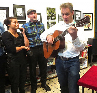Calvin Johnson performs at the <i>Sub Pop USA</i> book release party while Pavitt looks on. Photo by Gillian G. Gaar.