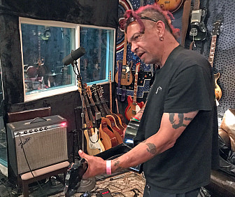 Chuck Mosley putting down guitar in the studio