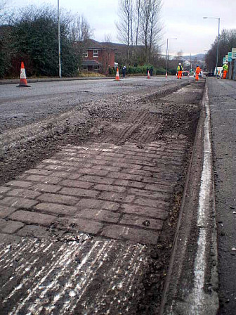 Road resurfacing to fix the holes in Blackburn, Lancashire. Note the cobblestones.<br>Photo: <a href="https://www.geograph.org.uk/photo/2244976" target="_blank">Tom Howard</a>, Geograph Project, CC 2.0