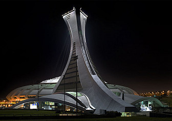 Montreal Olympic Stadium<br>Photo: <a href="https://en.wikipedia.org/wiki/File:Le_Stade_Olympique_de_Montr%C3%A9al_Nuit_Arriere-Gauche.jpg" target="_blank">Alain Carpentier</a>, via Wiki Commons, CC 3.0